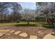 Expansive backyard featuring mature trees, lush greenery, and a serene atmosphere, perfect for outdoor enjoyment at 6715 Brookline Ct, Cumming, GA 30040