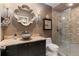 Updated bathroom featuring a stylish bowl sink, decorative mirror, and a tiled walk-in shower with glass door at 6715 Brookline Ct, Cumming, GA 30040