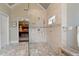 Beautiful bathroom with a glass enclosed shower, tile floors, and access to the main bedroom at 6715 Brookline Ct, Cumming, GA 30040