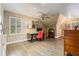 Bright bonus room with hardwood floors, a ceiling fan, and a desk area for work or study at 6715 Brookline Ct, Cumming, GA 30040