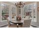 Bright breakfast nook with a chandelier, large windows, and comfortable seating with backyard views at 6715 Brookline Ct, Cumming, GA 30040