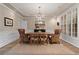 Elegant dining room with tray ceiling, plantation shutters, and a wood table at 6715 Brookline Ct, Cumming, GA 30040