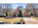 Charming two-story brick home with a well-manicured lawn and mature landscaping for great curb appeal at 6715 Brookline Ct, Cumming, GA 30040