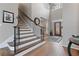 Open foyer with hardwood floors, statement lighting, and a staircase at 6715 Brookline Ct, Cumming, GA 30040