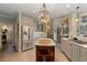 Open kitchen with stainless steel fridge, a center island and seamless transition to other rooms at 6715 Brookline Ct, Cumming, GA 30040