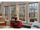 Bright living room with a wall of windows offering views of the landscaped backyard at 6715 Brookline Ct, Cumming, GA 30040