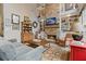 Cozy living room featuring a stone fireplace, built-in bookshelves, and hardwood floors at 6715 Brookline Ct, Cumming, GA 30040