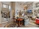 Spacious living room featuring a stone fireplace, built-in bookshelves, and hardwood floors at 6715 Brookline Ct, Cumming, GA 30040