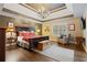 Elegant main bedroom with trey ceiling, chandelier, and stylish furnishings at 6715 Brookline Ct, Cumming, GA 30040