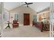 Main bedroom with a vaulted ceiling, seating area, windows with plantation shutters and an en suite room at 6715 Brookline Ct, Cumming, GA 30040