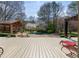 Inviting pool area with an open deck, lounge furniture, cabana, and landscaping for entertaining and relaxation at 6715 Brookline Ct, Cumming, GA 30040
