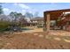 Inviting backyard pool area featuring a covered patio, ample seating, and a well-manicured lawn in a private setting at 6715 Brookline Ct, Cumming, GA 30040