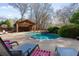 Inviting pool area surrounded by lush landscaping and lounge chairs, creating a perfect backyard retreat at 6715 Brookline Ct, Cumming, GA 30040