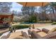 Relaxing pool area with a covered cabana, mature trees, lounge furniture, and a private outdoor escape at 6715 Brookline Ct, Cumming, GA 30040