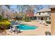 Stunning backyard with a luxurious pool, spa, and outdoor living spaces for ultimate relaxation and entertainment at 6715 Brookline Ct, Cumming, GA 30040