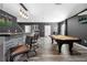 Finished basement with entertainment area featuring modern bar and pool table at 6117 Summerstone Ln, Douglasville, GA 30135