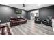 Finished basement featuring a contemporary entertaining space with leather seating and mounted TV at 6117 Summerstone Ln, Douglasville, GA 30135