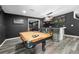 Finished basement with a pool table, bar area, contemporary lighting, and mounted TV at 6117 Summerstone Ln, Douglasville, GA 30135