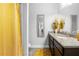 Modern bathroom featuring a granite countertop, decorative accents, and stylish gold shower curtain at 6117 Summerstone Ln, Douglasville, GA 30135