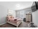 Cozy bedroom with soft pink accents and decor, plush carpeting and a large window at 6117 Summerstone Ln, Douglasville, GA 30135
