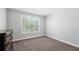 Bright bedroom with neutral carpet, fresh paint, and a window that provides natural light at 6117 Summerstone Ln, Douglasville, GA 30135