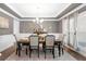 Formal dining room with large window, tray ceiling, and neutral color palette at 6117 Summerstone Ln, Douglasville, GA 30135