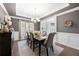 Elegant dining room with wainscoting, tray ceiling, and chandelier at 6117 Summerstone Ln, Douglasville, GA 30135
