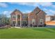 Elegant brick home with a manicured lawn and arched entryway at 6117 Summerstone Ln, Douglasville, GA 30135