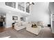 Bright living room with vaulted ceilings, large sofa, and staircase at 6117 Summerstone Ln, Douglasville, GA 30135