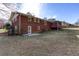 Back exterior of a brick home with fenced yard and deck at 6582 Malvin Dr, Mableton, GA 30168
