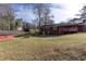 Expansive backyard with lush green grass and a storage shed, perfect for outdoor activities at 6582 Malvin Dr, Mableton, GA 30168