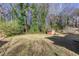 Spacious backyard featuring a storage shed, green grass, and mature trees at 6582 Malvin Dr, Mableton, GA 30168