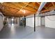 Unfinished basement with exposed wood ceiling, black support beams and concrete floor at 6582 Malvin Dr, Mableton, GA 30168