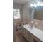 Functional bathroom with a classic sink, toilet, and vanity, complemented by neutral tiling and ample natural light at 6582 Malvin Dr, Mableton, GA 30168