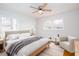 Inviting bedroom featuring hardwood floors, a plush bed, and a cozy sitting area, bathed in natural light at 6582 Malvin Dr, Mableton, GA 30168