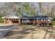Charming single-story brick home with a covered carport and neatly landscaped front yard at 6582 Malvin Dr, Mableton, GA 30168