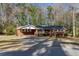 Charming single-story brick home with a cozy carport, a well-maintained lawn, and mature trees at 6582 Malvin Dr, Mableton, GA 30168