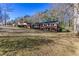 Single-story brick home with a well-maintained lawn and mature trees enhancing its curb appeal at 6582 Malvin Dr, Mableton, GA 30168