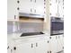 Kitchen area features stainless steel oven and white cabinets with bronze hardware at 6582 Malvin Dr, Mableton, GA 30168