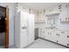 Bright kitchen with white cabinets, updated appliances, and a window above sink at 6582 Malvin Dr, Mableton, GA 30168