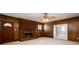 Spacious living room with hardwood flooring, a brick fireplace, and double doors leading to the backyard at 6582 Malvin Dr, Mableton, GA 30168