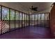 Enclosed back porch with stained wood floor, ceiling fan, and latticework at 6582 Malvin Dr, Mableton, GA 30168