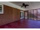 Enclosed back porch with stained wood floor, ceiling fan, and latticework at 6582 Malvin Dr, Mableton, GA 30168