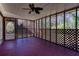 Enclosed back porch with stained wood floor, ceiling fan, and latticework at 6582 Malvin Dr, Mableton, GA 30168