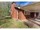 Brick home with a covered carport featuring an exterior side door and a small chimney at 6582 Malvin Dr, Mableton, GA 30168