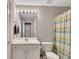 A bright bathroom featuring a vanity with good lighting and a shower with a striped shower curtain at 6690 Cold Stream Dr, Cumming, GA 30040