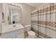 Inviting bathroom featuring a vanity, toilet, and a shower with a patterned shower curtain at 6690 Cold Stream Dr, Cumming, GA 30040