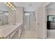 Bright bathroom featuring a shower with glass doors and a vanity with a large mirror at 6690 Cold Stream Dr, Cumming, GA 30040