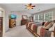 Comfortable bedroom with neutral colors, carpet, ample natural light, and ceiling fan at 6690 Cold Stream Dr, Cumming, GA 30040