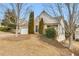Attractive home featuring a two-car garage, mature trees, and well-kept landscaping on a gentle slope at 6690 Cold Stream Dr, Cumming, GA 30040